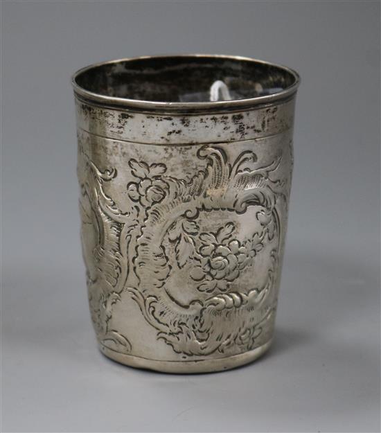 An 18th century? Russian repousse white metal beaker decorated with bird and foliage amid scrolls, 76mm.
